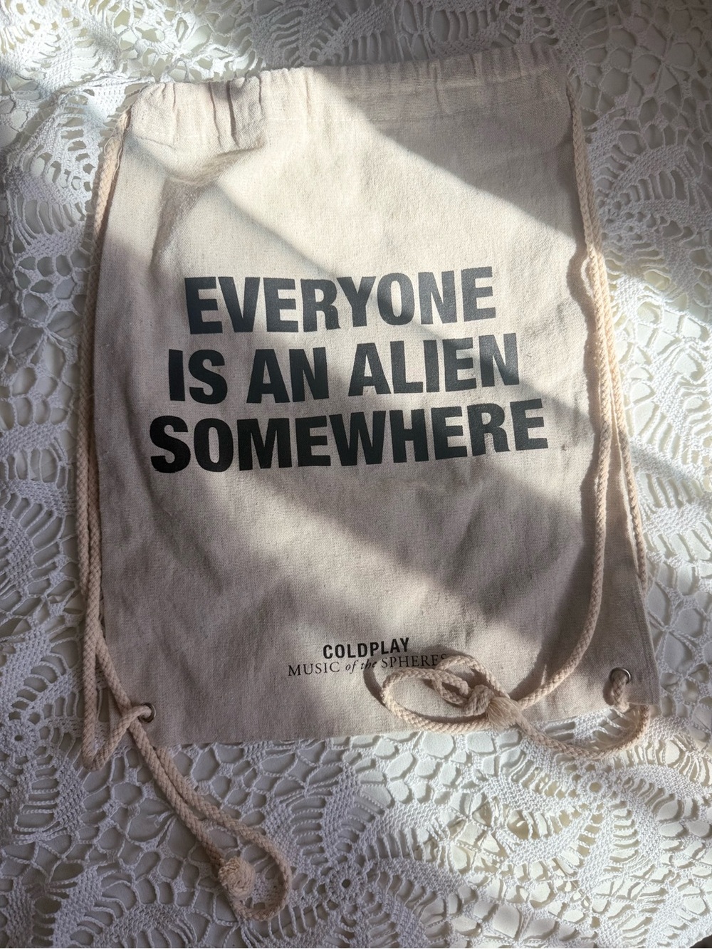 Coldplays “Everyone Is An Alien Somewhere' Beige Drawstring Bag